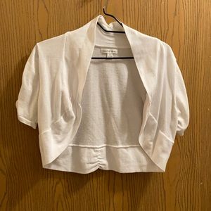 L white knit short sleeved shrug.